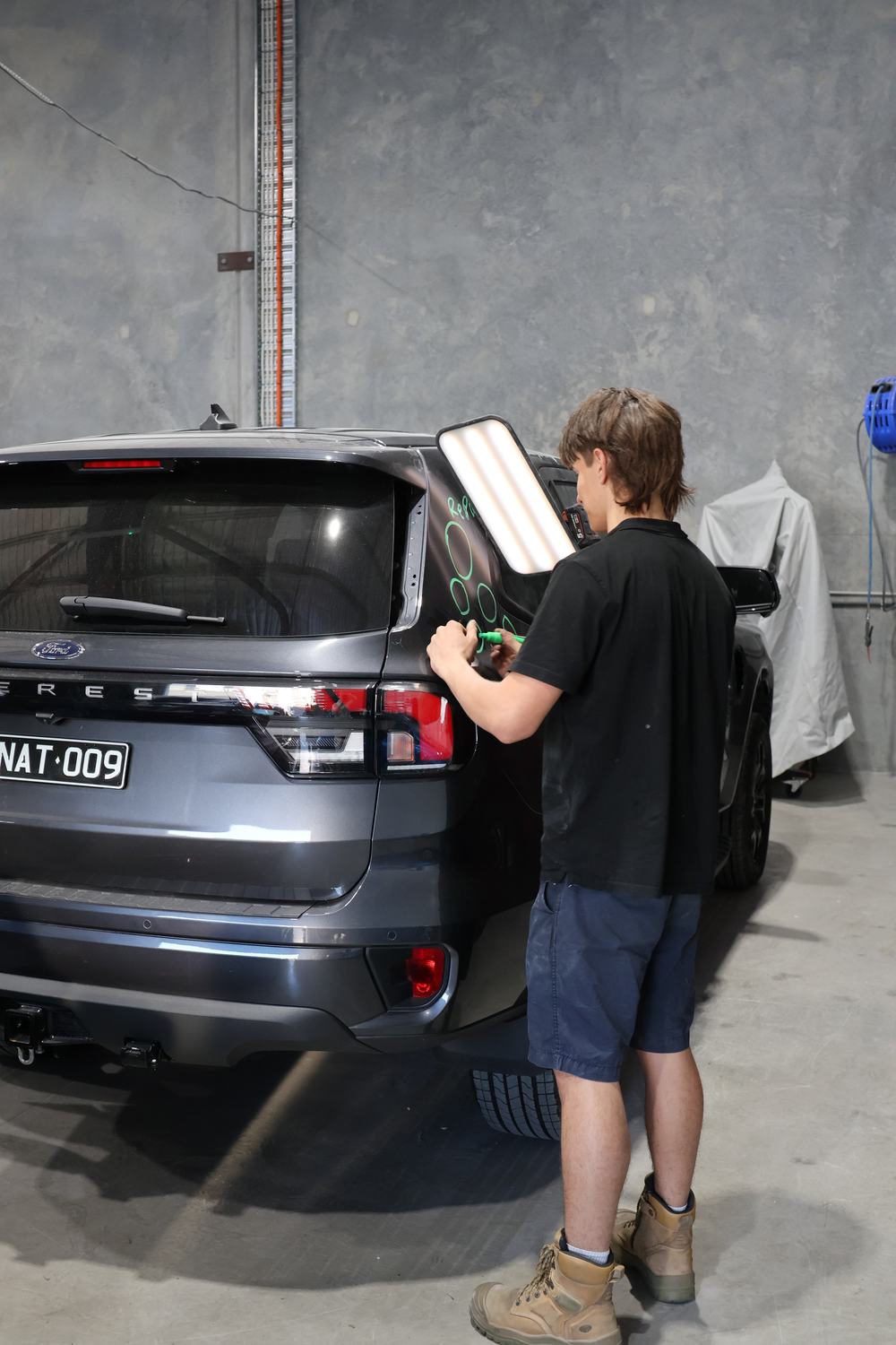 Panel dent assessment markings during repair at MRP Automotive Refinishing, Redland Bay