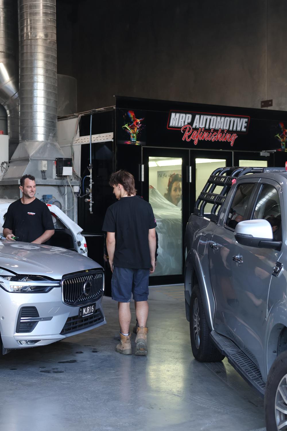 Inside the MRP Automotive Refinishing workshop — downdraft spray booth and repair bays