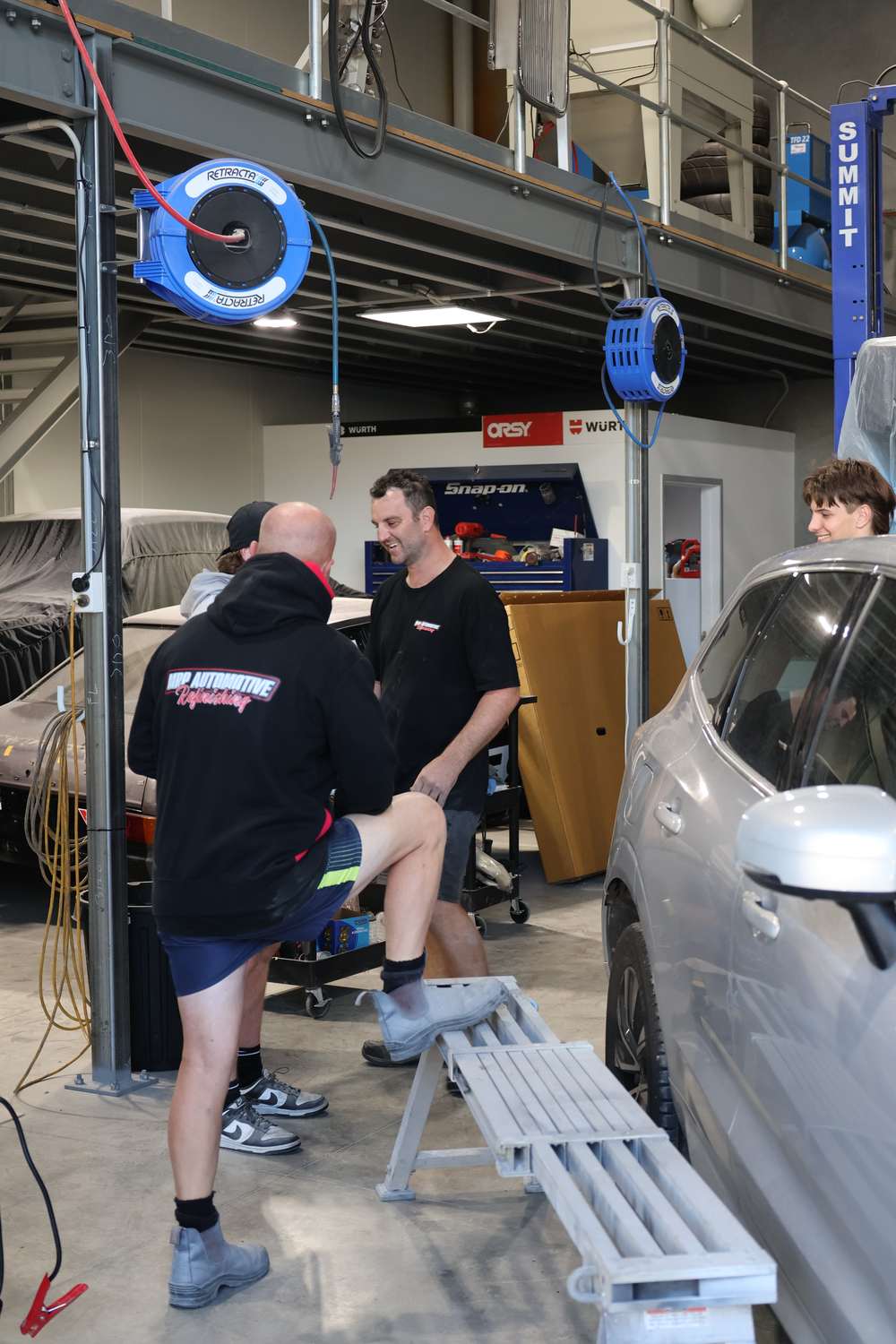 MRP Automotive Refinishing technicians working on a vehicle in the Redland Bay workshop
